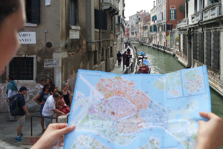 Tourists exploring Venice's canals and historic streets with a map in hand.